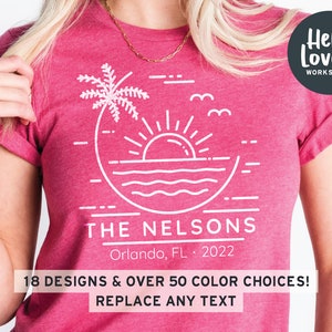 May include: A pink t-shirt with a white graphic design of a palm tree, sun, and ocean waves. The text "THE NELSONS" is below the graphic, along with "Orlando, FL 2022". The text "Hello Lovely WORKSHOP" is in a circle in the upper right corner of the shirt.