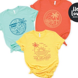 May include: Three t-shirts with a beach theme. The first t-shirt is light blue with the text "CAMPBELL FAMILY" and a palm tree. The second t-shirt is orange with the text "THE LANSON FAMILY" and a palm tree. The third t-shirt is yellow with the text "THE NELSONS" and a palm tree.