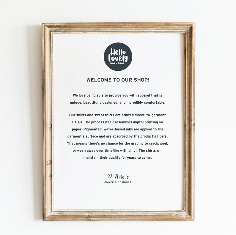 May include: A framed print with the text "Hello Lovely Workshop" and "Welcome to Our Shop!" The text describes the apparel as unique, beautifully designed, and comfortable. The print is in a light brown wooden frame.
