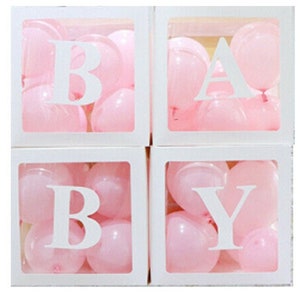 May include: Four white boxes with clear plastic windows filled with pink balloons. Each box has a white letter on the front, spelling out the word "BABY".