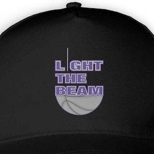 May include: Black baseball cap with a purple and white basketball graphic and the text "LIGHT THE BEAM" in purple.