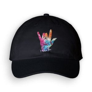 May include: Black baseball cap with a tie-dye print of the American Sign Language symbol for "I love you".