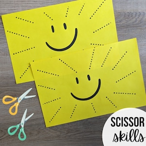 May include: Two yellow paper sheets with black dotted lines radiating from a black smiley face on each sheet. The text "SCISSOR skills" is printed in black on a white circle at the bottom of the image. Two pairs of scissors are shown below the sheets.