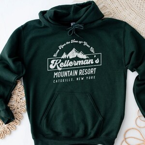 May include: A dark green hooded sweatshirt with a white vintage-style graphic that reads "Come Have the Time of Your Life Kellerman's Mountain Resort Catskills, New York".