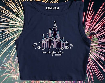 May include: A navy blue sleeveless crop top with a white outline of Cinderella's castle and the text "magic est 1971".