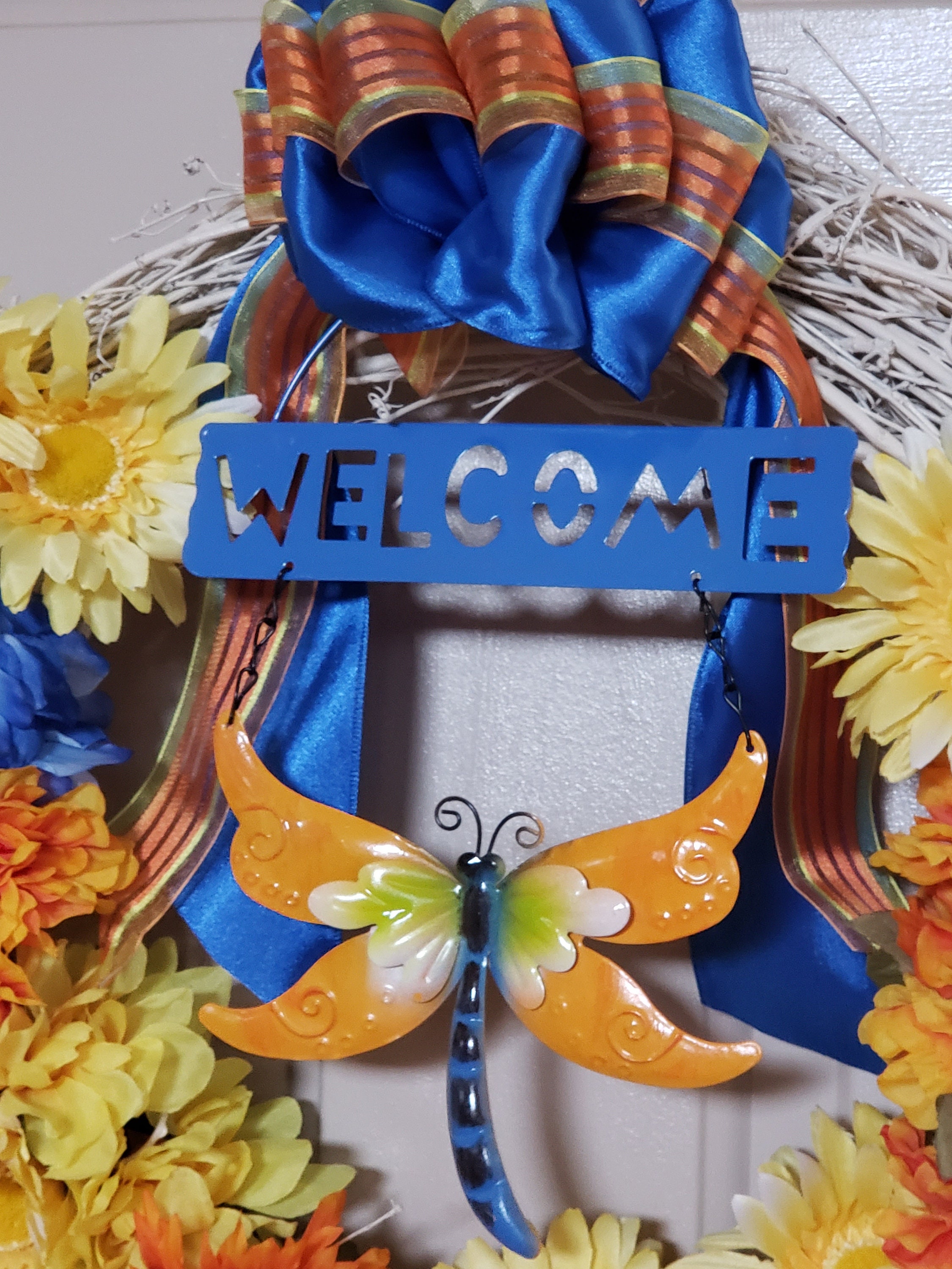 Welcome Wreath Reads \u201c Welcome \u201c with Dragonflies Flowers and Watering Bucket Perfect for Spring Time Hanging Door Wreath Welcome Wreath Reads \u201c Welcome \u201c with Dragonflies Flowers and Watering Bucket Perfect for Spring Time Hanging Door Wreath
