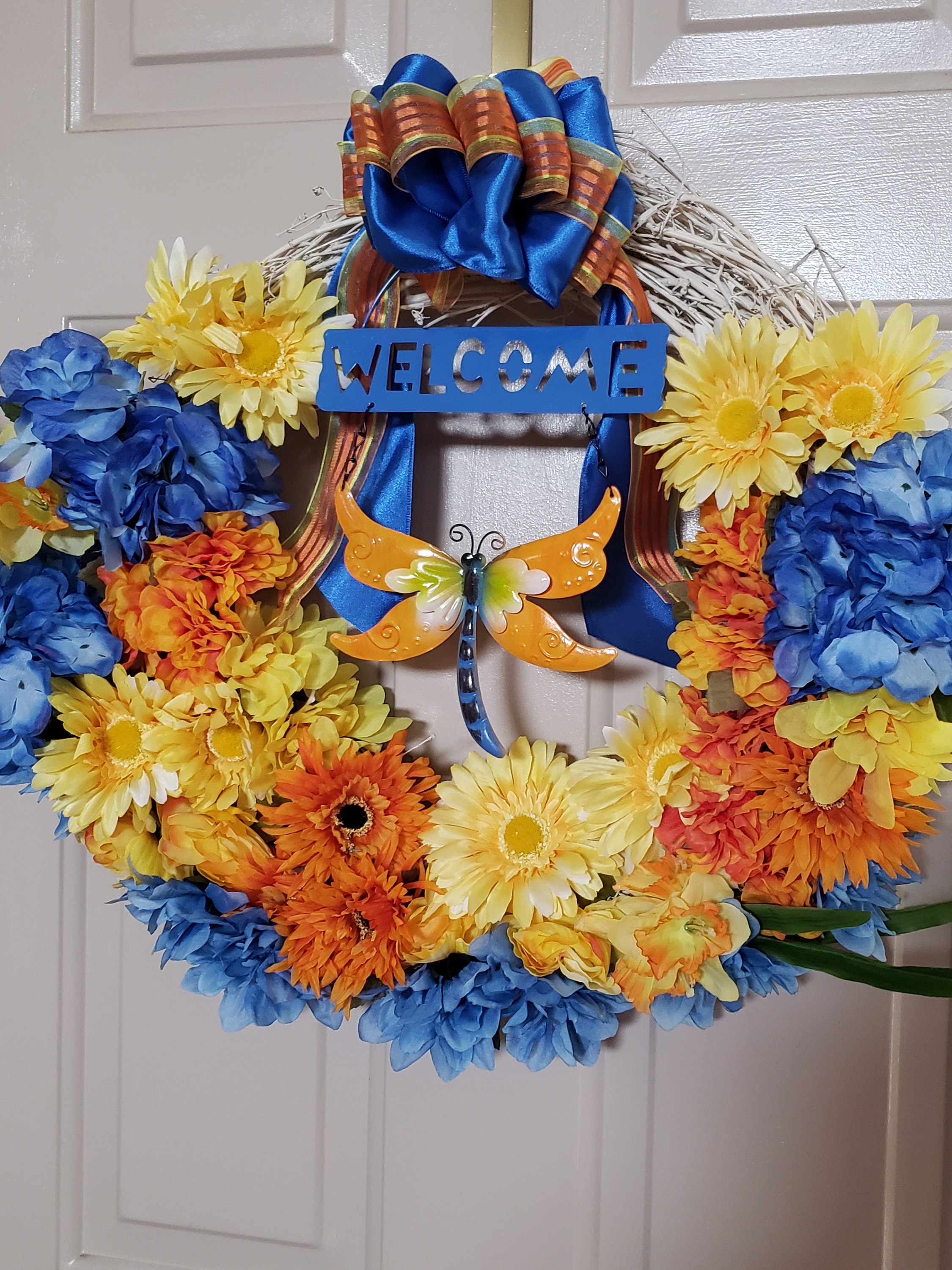 Welcome Wreath Reads \u201c Welcome \u201c with Dragonflies Flowers and Watering Bucket Perfect for Spring Time Hanging Door Wreath