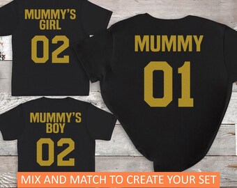 May include: Three black t-shirts with gold lettering. The shirts say "Mummy's Girl 02", "Mummy's Boy 02", and "Mummy 01".