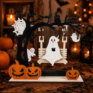 May include: A wooden Halloween tabletop decoration featuring a black tree with a white spiderweb, a swing holding a white ghost with a black mug, a hanging ghost, an owl, and three orange jack-o'-lanterns on a flat rectangular base.
