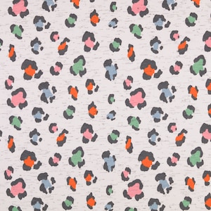 May include: A white fabric with a repeating pattern of black, pink, blue, green, and orange leopard spots.