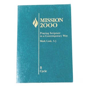 May include: A teal-colored book titled "MISSION 2000" with gold lettering and a flame graphic. The book's subtitle reads "Praying Scripture in a Contemporary Way" by Mark Link, S.J. The bottom of the book reads "B Cycle".