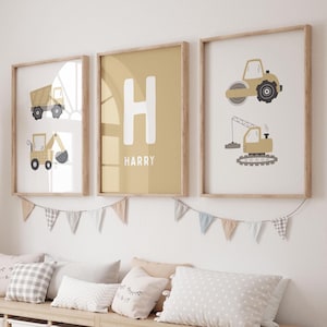 May include: Three framed wall art prints featuring construction vehicles and the letter H with the name Harry. The left print shows a dump truck and excavator, the center print displays a large letter H and the name Harry, and the right print features a road roller and crane.