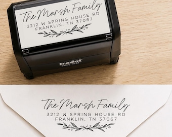 May include: Black address stamp with the text "The Marsh Family" and address details in a script font. The stamp includes a decorative floral design. A stamped envelope shows the same address.