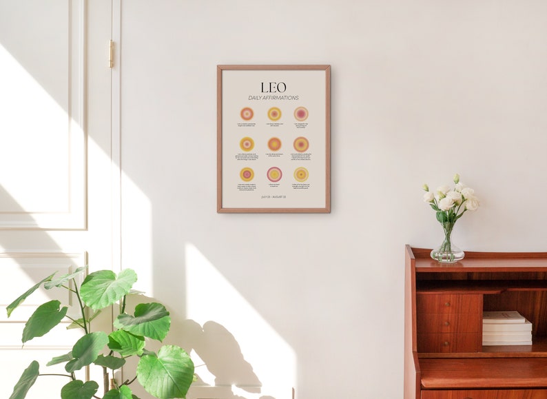 May include: A framed print with the text "LEO DAILY AFFIRMATIONS" and a series of colorful circles with affirmations for the zodiac sign Leo. The dates July 23 - August 22 are listed at the bottom of the print.