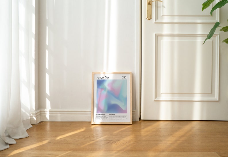 May include: A framed print with a light blue, pink, and purple abstract design. The print has the text "Angel No. 533" at the top.