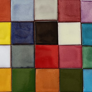 May include: A collection of 20 small square tiles in various colors, including red, yellow, blue, green, white, black, and purple. The tiles are arranged in a grid pattern.