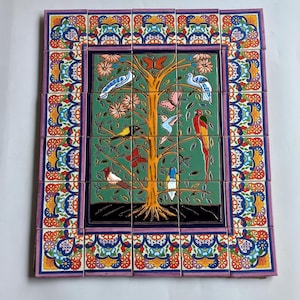 May include: A rectangular wall art piece composed of twenty ceramic tiles featuring a central green panel with a yellow tree, various colorful birds, and butterflies. The border consists of intricate floral patterns in blue, red, and orange.