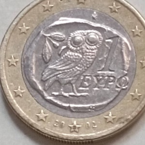 Currency 1 Euro Owl Greece 2010. Huge typo in the right eye of the owl  appears a 1.
