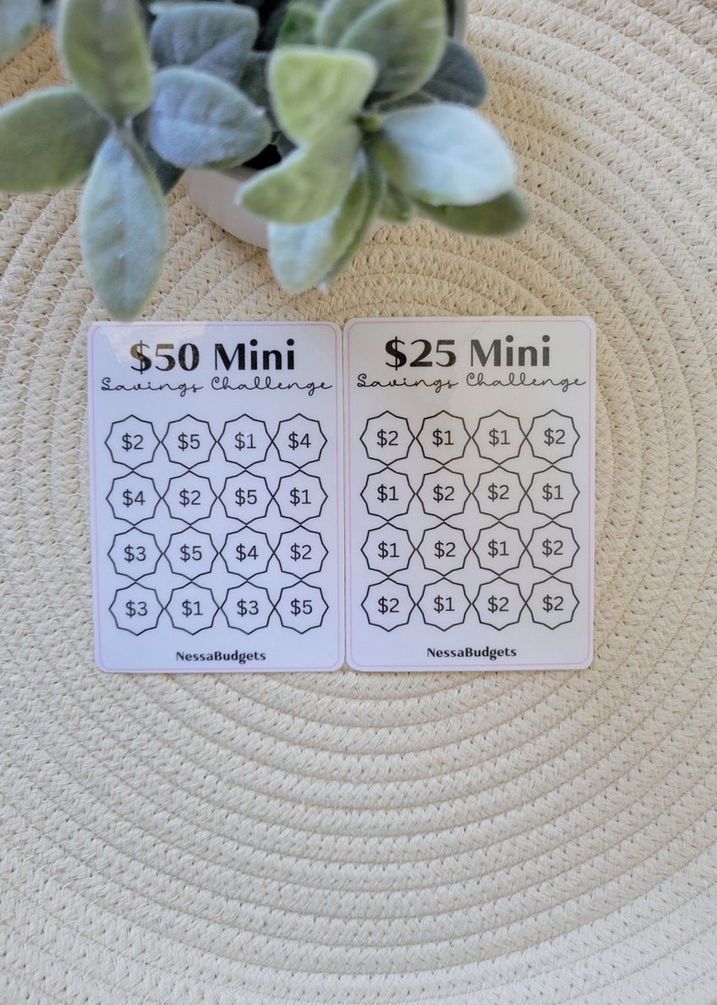 May include: Two white cards with black text and borders. The cards are titled "$50 Mini Savings Challenge" and "$25 Mini Savings Challenge". Each card has a grid of 16 squares with dollar amounts in each square. The amounts are $1, $2, $3, $4, and $5.