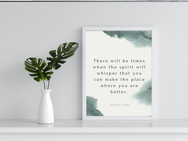 May include: A framed print with a quote about finding peace and making things better. The quote is by Sharon G. Larsen and is printed on a white background with a watercolor-like design in shades of blue and green.
