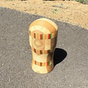 May include: A set of three ceramic mugs with a speckled, matte finish. The mugs are in shades of cream, light gray, and dark gray. Each mug has a simple, minimalist design and a rounded handle. The mugs are stacked on top of each other.