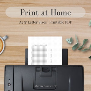May include: A black and white printable planner sheet with a grid layout and checkboxes. The sheet is being fed into a black printer. The text "Print at Home" and "A5 & Letter Sizes | Printable PDF" is displayed above the printer. The text "MIXED PAPERY CO." is displayed below the printer.