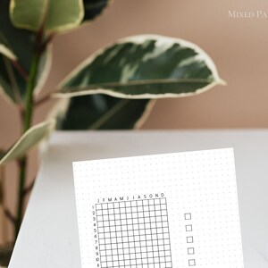 May include: A white sheet of paper with a grid of 12 columns and 10 rows. The grid is labeled with the months of the year and numbers 1 through 10. There are four empty boxes to the right of the grid.