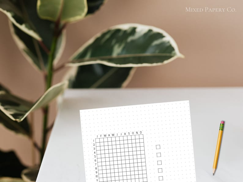May include: A white sheet of paper with a grid of 12 columns and 10 rows. The grid is labeled with the months of the year and numbers 1 through 10. There are four empty boxes to the right of the grid.