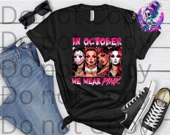 May include: Black t-shirt with the text "IN OCTOBER WE WEAR PINK" and a graphic of four women in Halloween costumes. The shirt is paired with blue jeans, black sunglasses, and black sneakers.