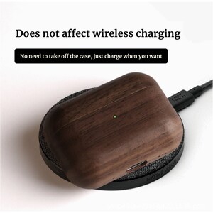May include: A brown wooden case for wireless earbuds is on a black wireless charging pad. The case has a green light indicating it is charging. The text "NATIVE UNION" is visible on the charging pad.