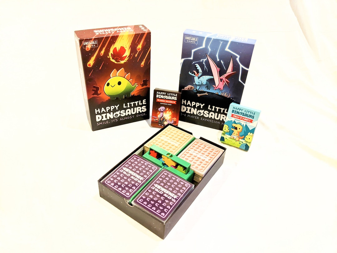 Unstable Games | Happy Little Dinosaurs – Espansione per 5 – 6 Persone | Gioco di Carte | 2 – 6 Giocatori | a Partire da 8 Anni | 30 – 60 Minuti | Tedesco : Badie, Ramy