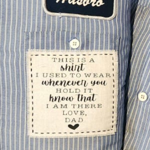 May include: A blue and white striped shirt with a Hasbro patch. A white patch on the pocket reads "THIS IS A shirt I USED TO WEAR whenever you HOLD IT know that I AM THERE LOVE, DAD".