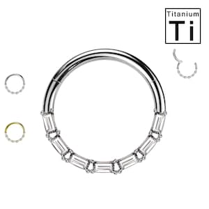 May include: Titanium seamless ring with a row of clear baguette-shaped gems. The ring is made of titanium and is available in different sizes.