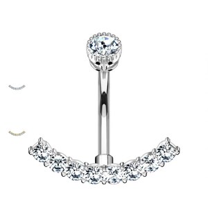May include: Silver belly button ring with a clear crystal top and a curved row of clear crystals on the bottom.