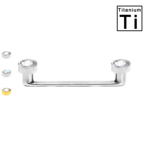 May include: A silver titanium dermal anchor with a clear, round gem at each end. The anchor is straight with a 90-degree bend at each end. The image also shows three smaller, round dermal anchors in silver and gold. The word "Titanium" and the symbol "Ti" are in the upper right corner.