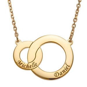 May include: Gold necklace with two interlocking circles, each engraved with a name. The names are "Michelle" and "Daniel".