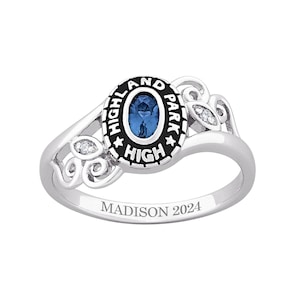 May include: A silver-colored class ring with an oval blue gemstone at the center. The ring features the words "HIGHLAND PARK HIGH" in black lettering around the gemstone. The ring is engraved with "MADISON 2024".
