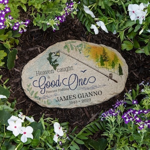 May include: A memorial stone with a fishing scene and the text "Heaven caught a good one. Forever Fishing. JAMES GIANNO 1943 - 2023".