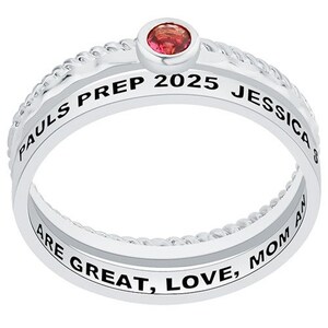 May include: A silver ring with a red stone and the inscription "PAULS PREP 2025 JESSICA ARE GREAT, LOVE, MOM AND"