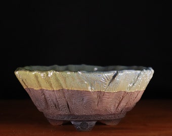 Roundish bonsai pot with highly textured surface and glazed rim (7")