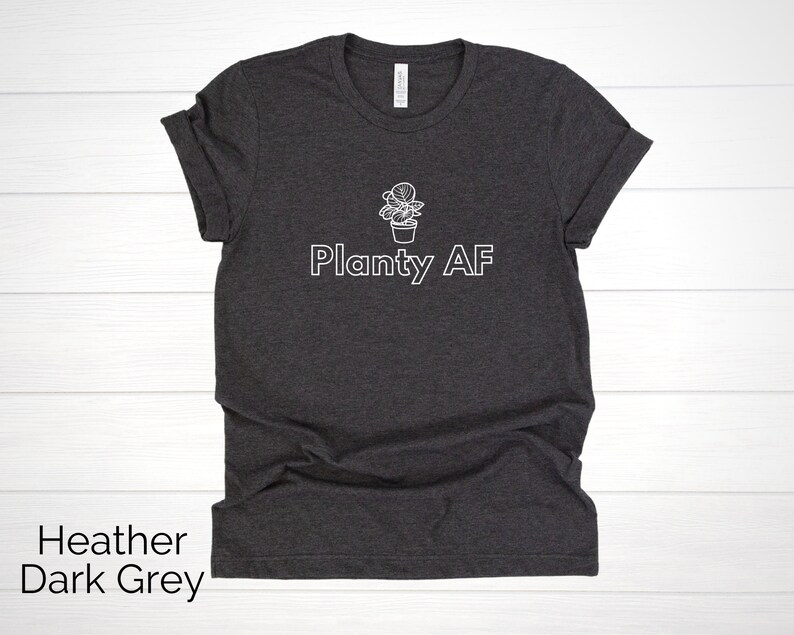 May include: Heather dark grey t-shirt with a white outline of a potted plant and the text "Planty AF".