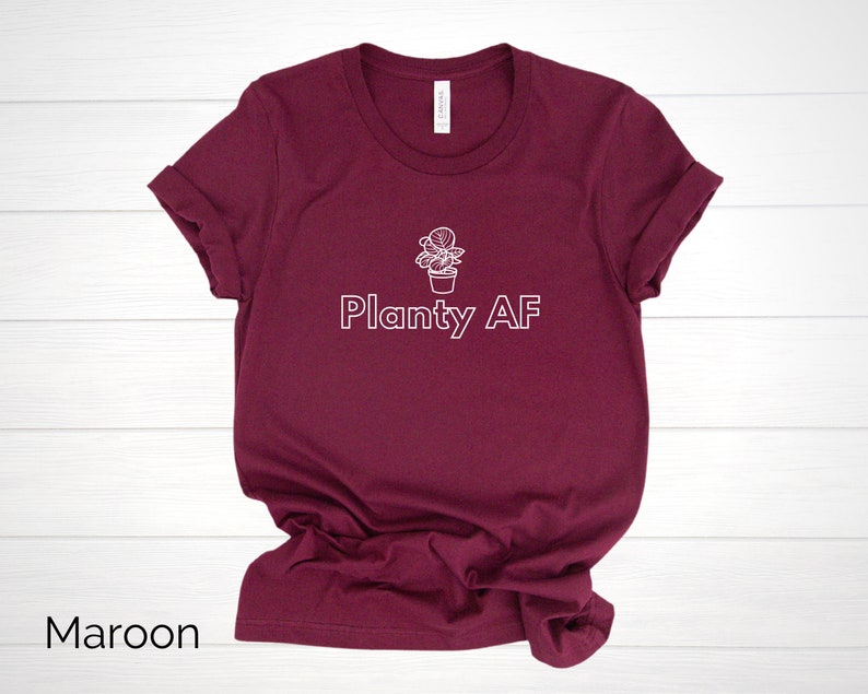 May include: A maroon t-shirt with a white outline of a potted plant and the text "Planty AF".