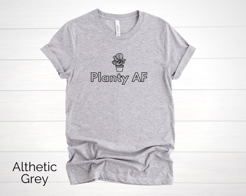 May include: A heather grey t-shirt with a black outline of a potted plant and the text "Planty AF".