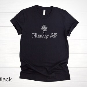 May include: Black t-shirt with a white outline of a potted plant and the text "Planty AF".