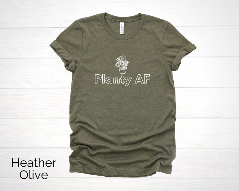 May include: A heather olive t-shirt with a white graphic of a potted plant and the text "Planty AF".