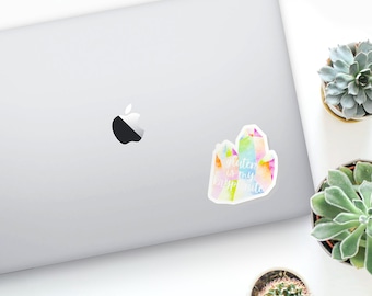 May include: A sticker with a watercolor-style illustration of a rainbow crystal with the text "Gluten is my kryptonite" on a laptop.