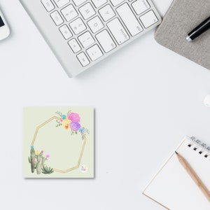 May include: A light green square card with a gold geometric frame and watercolor flowers. The flowers are pink, yellow, and purple. The card has the text "My Tribe" in a circle at the bottom.