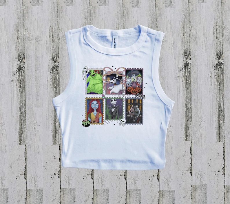 May include: White vest top with a colourful graphic of postage stamps featuring characters from The Nightmare Before Christmas. The stamps include images of Jack Skellington, Sally, and Oogie Boogie.