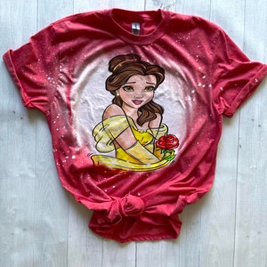 May include: Red t-shirt with a bleach-splattered design featuring a cartoon image of Belle from Beauty and the Beast holding a red rose.