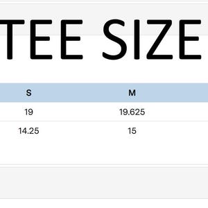 May include: A baby tee size chart with measurements in inches. The chart includes sizes XS to 2XL, listing body length and body width for each size. The text "BABY TEE SIZE CHART" is prominently displayed at the top.